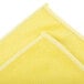 A yellow Unger SmartColor microfiber cloth folded in half.