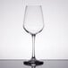 A close-up of a Libbey Vina tall wine glass on a table with a reflection.