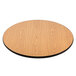 A Lancaster Table & Seating round table with reversible walnut and oak finish on a cross cast iron base.