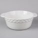 A close up of a Tuxton Bright White Band round casserole dish with handles.