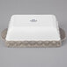 A white rectangular Tuxton casserole dish with a grey truffle design on the surface.