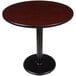 A Lancaster Table with Round Black Base and Reversible Cherry/Black Top.