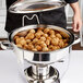 A Vollrath stainless steel food pan with meatballs in it.