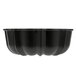 A black non-stick aluminum fluted cake pan with a curved design.