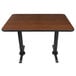 A Lancaster Table & Seating rectangular table with a black base and reversible walnut/oak top.