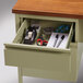The open right corner drawer on a Hirsh Industries pedestal desk with a pen holder and paper organizer inside.