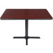 A Lancaster Table & Seating table with a black base and reversible cherry/black top.