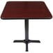 A Lancaster Table & Seating square table with a black base and reversible cherry/black top.