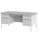 A gray Hirsh Industries double pedestal desk with drawers on both sides.