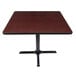 A Lancaster Table & Seating table with a reversible cherry and black top on a black base.