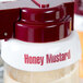 A Tablecraft white plastic lid with maroon lettering for honey mustard.