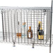 Metro Super Erecta security module with metal wire shelves inside a metal cage holding clear plastic bottles with blue caps.
