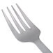 A close-up of an American Metalcraft hammered stainless steel cold meat fork with a white background.