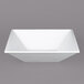 A white square bowl with a textured finish on a gray background.