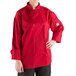 A woman wearing a Mercer Culinary red long sleeve chef jacket with a full mesh back.