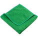 A green Unger SmartColor microfiber cleaning cloth folded on a table.