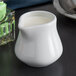 Tuxton BPR-0352 3.5 oz. Porcelain White China Creamer - 12/Case Main Thumbnail 1