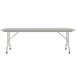 A white rectangular Correll folding table with a gray metal base.