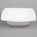 A Bone White square porcelain bowl on a gray background.