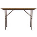 A brown rectangular Correll folding table with black legs.
