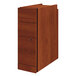 A HON Cognac laminate wooden cabinet with three drawers.