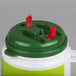 A green and white plastic container with red straws and a lid with red handles.