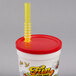 A white plastic "Fun at the Fair" souvenir cup with a red lid and straw holder with a yellow straw.