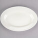 Choice 9 3/8" x 6 1/2" Ivory (American White) Wide Rim Rolled Edge Oval Stoneware Platter - 24/Case Main Thumbnail 3