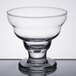 A clear Libbey dessert glass with a pedestal on a table.