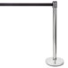 A silver Lancaster Table & Seating crowd control stanchion with a black ribbon.