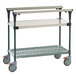 A stainless steel Metro PrepMate Multistation cart with wheels and two shelves.