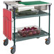 A Metro PrepMate cart with red and green containers of vegetables on it.