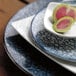 A Schonwald porcelain coupe plate with watermelon slices on it.