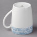 A white porcelain mug with a blue structure on it.