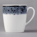 A Schonwald stone porcelain coffee mug with a black and white speckled surface and handle.