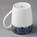 A white Schonwald stone porcelain mug with black and white speckles.