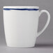 A white porcelain tall cup with a blue line on the top and bottom.