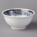 A white Schonwald porcelain bowl with black specks on it.