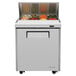 A Turbo Air stainless steel refrigerated sandwich prep table with an open door and food inside.