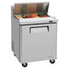 A Turbo Air stainless steel refrigerated sandwich prep table with food in it.