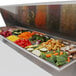 A Turbo Air refrigerated sandwich prep table with trays of vegetables and meat.