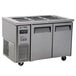 A large stainless steel refrigerated buffet display table with three doors.