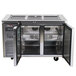 A stainless steel refrigerated buffet display table with glass doors.