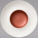 A white porcelain deep plate with a copper well and rim.