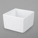 A white cube container with a square top.