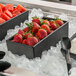 A G.E.T. Enterprises Bugambilia black rectangular salad bowl filled with watermelon cubes on a tray of ice.