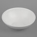 A white G.E.T. Enterprises Bugambilia sphere bowl on a gray surface.