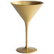 A close-up of a Stolzle gold martini glass with a long stem.