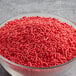 A bowl of red sprinkles.