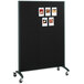 A black Quartet room divider with pictures on it.